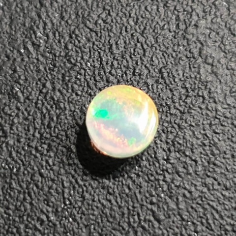 Opal from Ethiopia cabochon fi 7 mm no 412 Opal from Ethiopia cabochon fi 7 mm no 412
